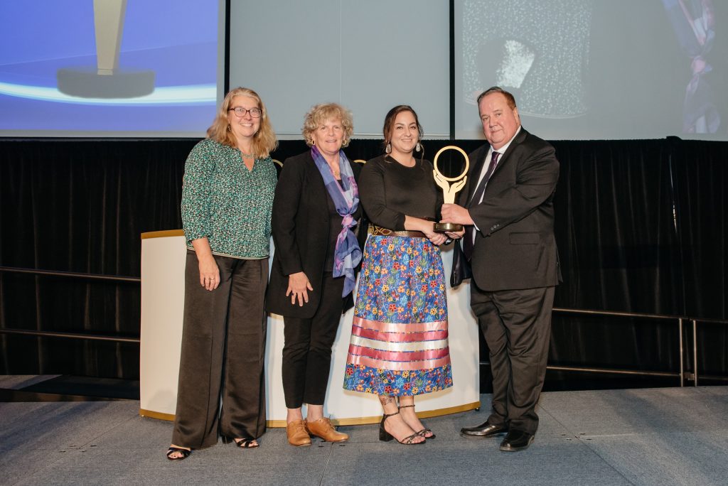 Image of Chief Don Maracle presenting the Improved Indigenous Health Award to the Bringing Specialist Care Close to Home Team