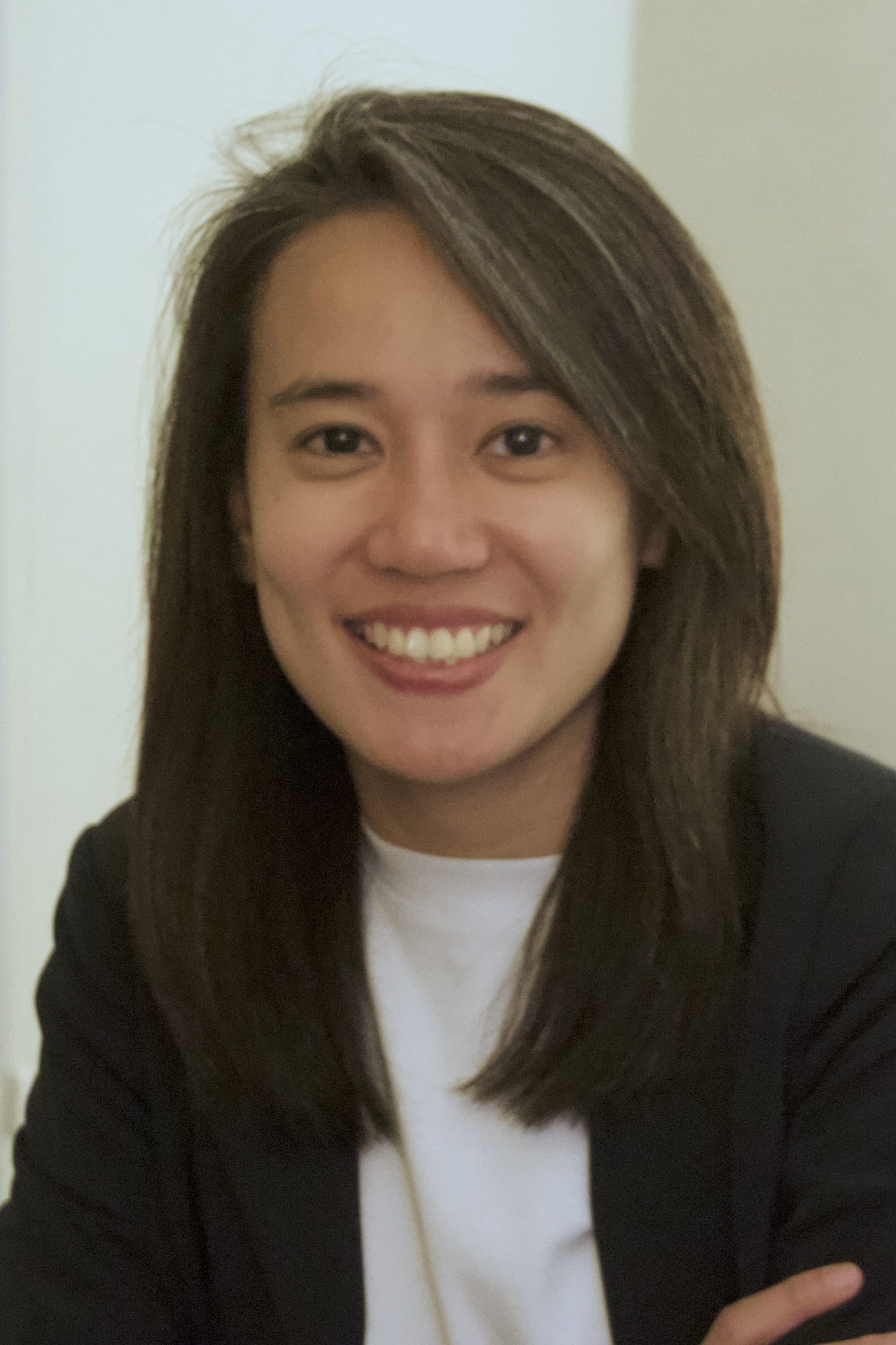 Camellia Zakaria wearing a blazer and smiling at the camera