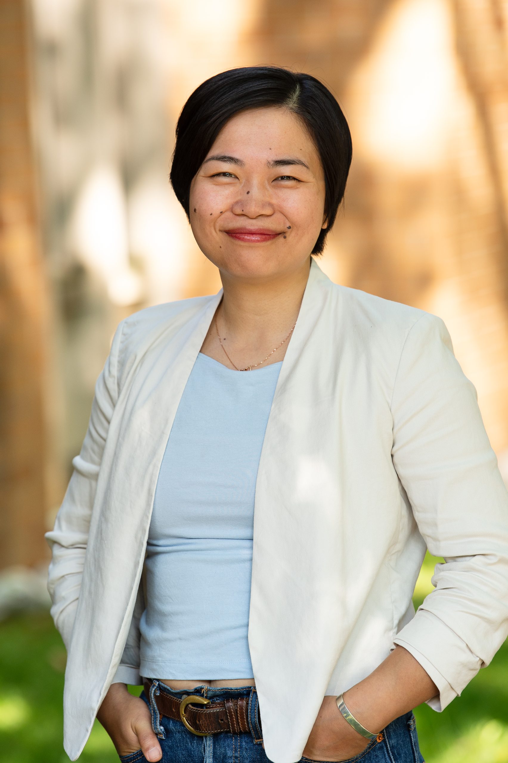 Headshot of Jane Zhao smiling and wearing a white blazer