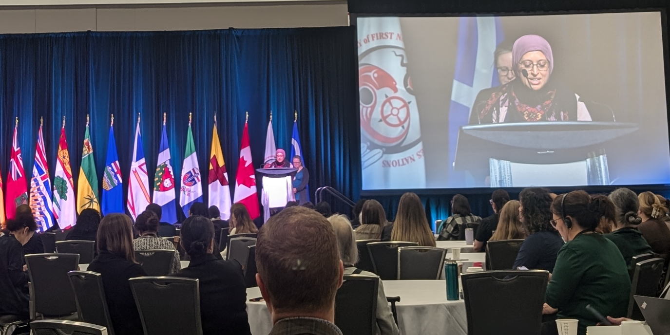 Shaza Fadel accepts the mid-career award at the podium of the Canadian Immunization Conference 2024 in Ottawa