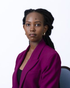 A person in a purple blazer sitting in a chair.